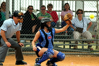 Female Softball Catcher Blocking Ball in Blue Gear
