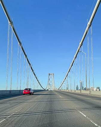 Red car driving on San Francisco Bay Bridge