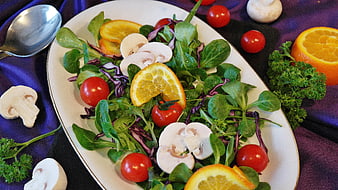 Fresh Mixed Green Salad with Orange Slices and Cherry Tomatoes