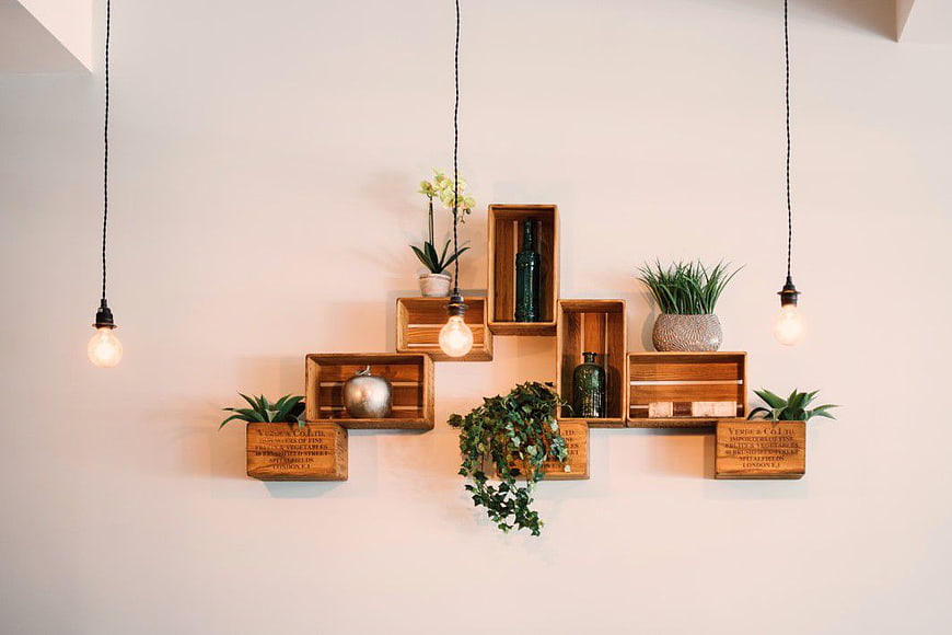 Rustic wooden crates wall shelves with plants and lights