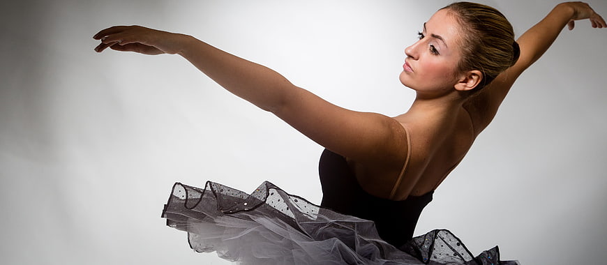 Elegant ballerina in black tutu posing gracefully
