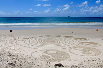 Beach Sand Art With Yin Yang Symbols And Ocean Horizon
