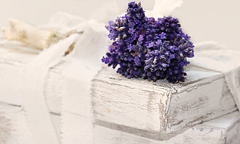 Dried lavender bouquet on stack of white shabby chic books