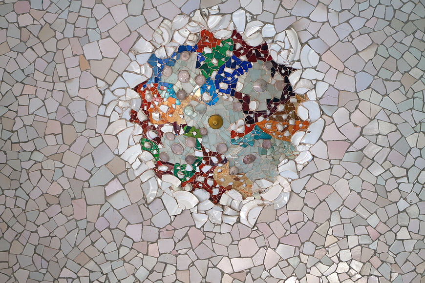 Colorful Gaudi Mosaic Detail on White Ceramic Tile Background