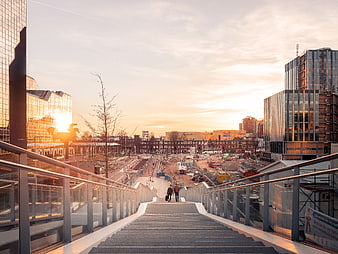 Modern city stairs at sunrise with construction site view