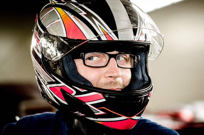 Man Wearing Racing Helmet and Glasses Looking Sideways