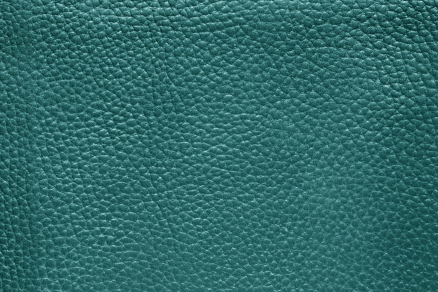 Close-up of textured teal leather surface background