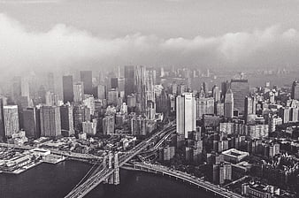 Black and white aerial view of Manhattan skyline and Brooklyn Bridge