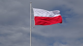 Polish flag waving against cloudy sky