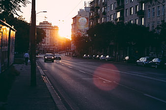 Golden Hour City Street with Lens Flare and Traffic
