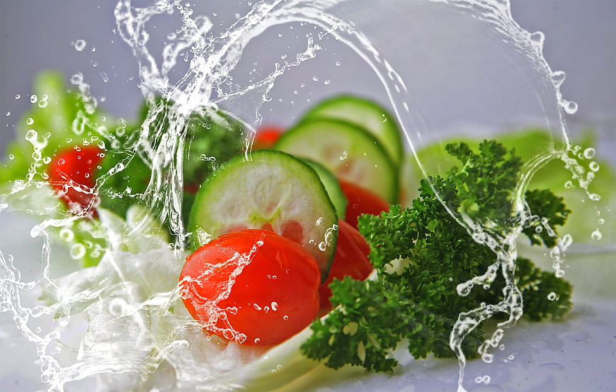 Fresh salad with water splash and vibrant vegetables