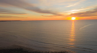 Serene Ocean Sunset with Golden Reflection on Calm Water