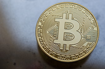 Gold Bitcoin Coin Close-Up on Textured Surface