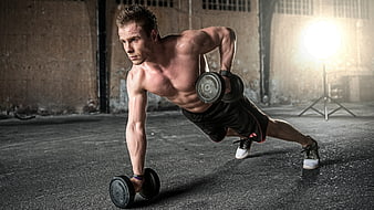 Muscular Man Performing Dumbbell Row in Industrial Gym
