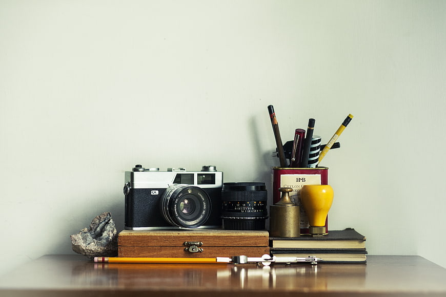 Vintage Camera and Stationery Still Life on Wooden Desk