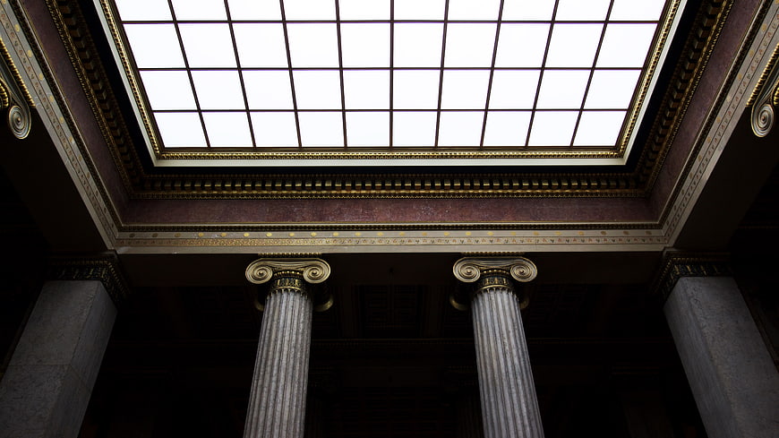 Low angle view of classical columns and skylight ceiling