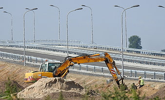 Yellow Excavator Digging Near New Highway Viaduct Construction Site