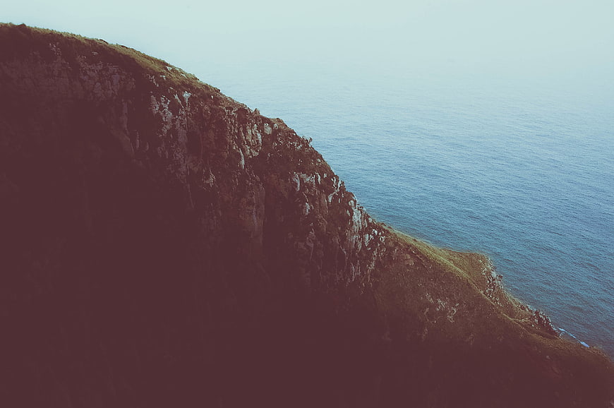 Dramatic Coastal Cliff Overlooking Blue Ocean