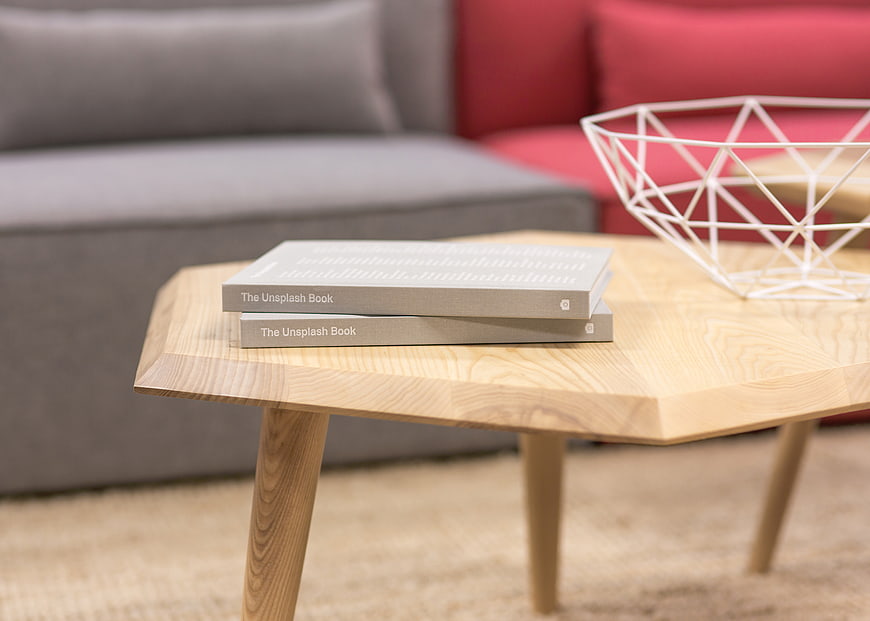 Modern wooden coffee table with books and geometric bowl