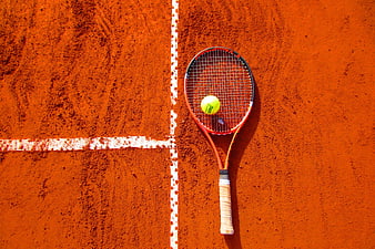 Tennis Racket and Ball on Clay Court