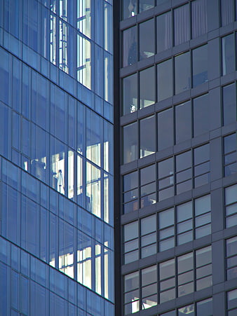 Modern Glass Office Building Facade with Blue Reflections