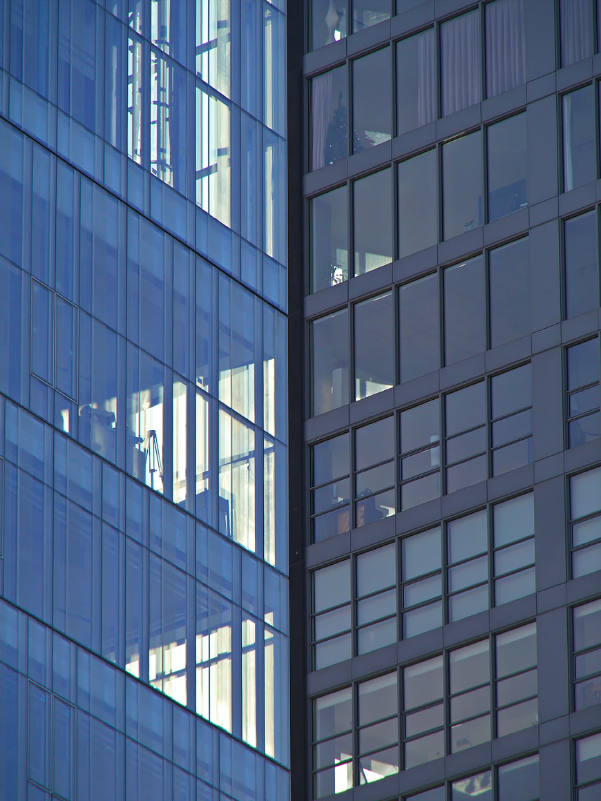 Modern Glass Office Building Facade with Blue Reflections
