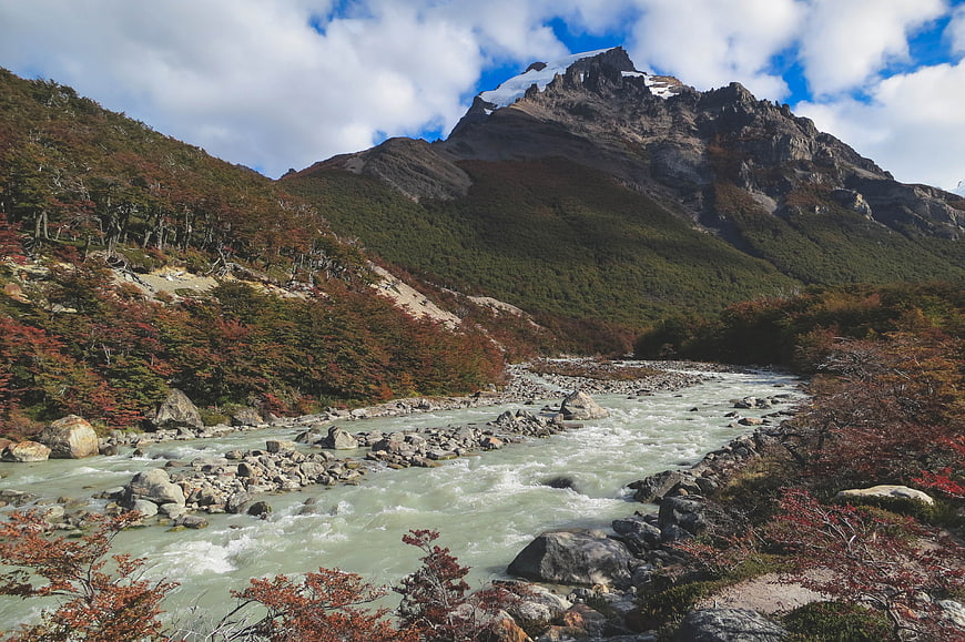 Glacial river flowing through Patagonian mountains in autumn