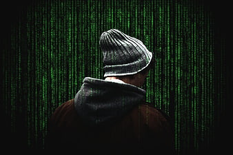 Anonymous Hacker in Beanie with Green Matrix Code Background