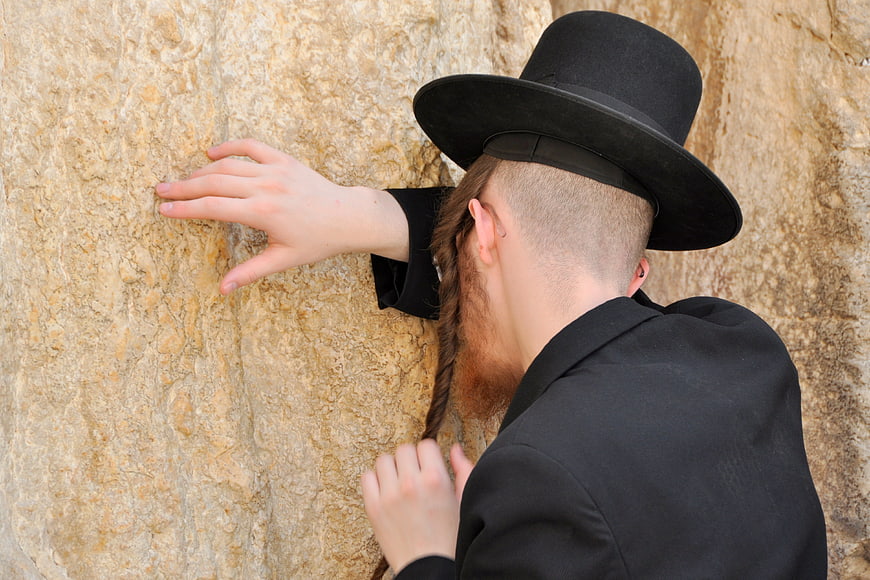 Haredi Jewish man praying at the Western Wall in Jerusalem
