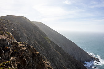 Dramatic coastal cliff landscape with ocean view and rugged terrain