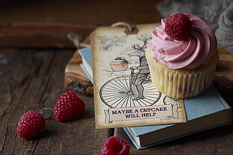 Raspberry cupcake on vintage tag with book and berries