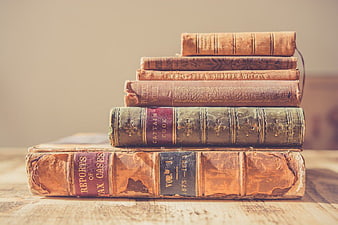 Stack of Vintage Antique Books on Wooden Table