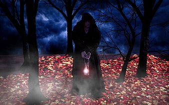Mysterious hooded figure holding lantern in dark forest
