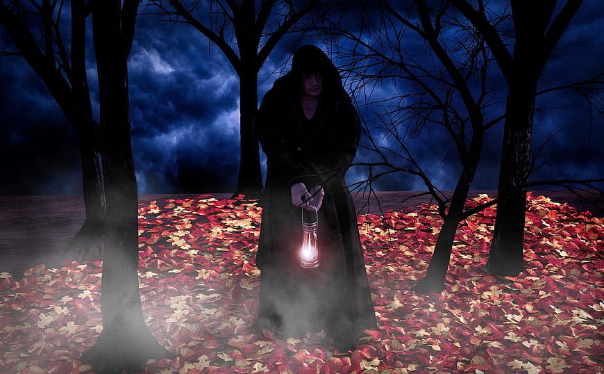 Mysterious hooded figure holding lantern in dark forest