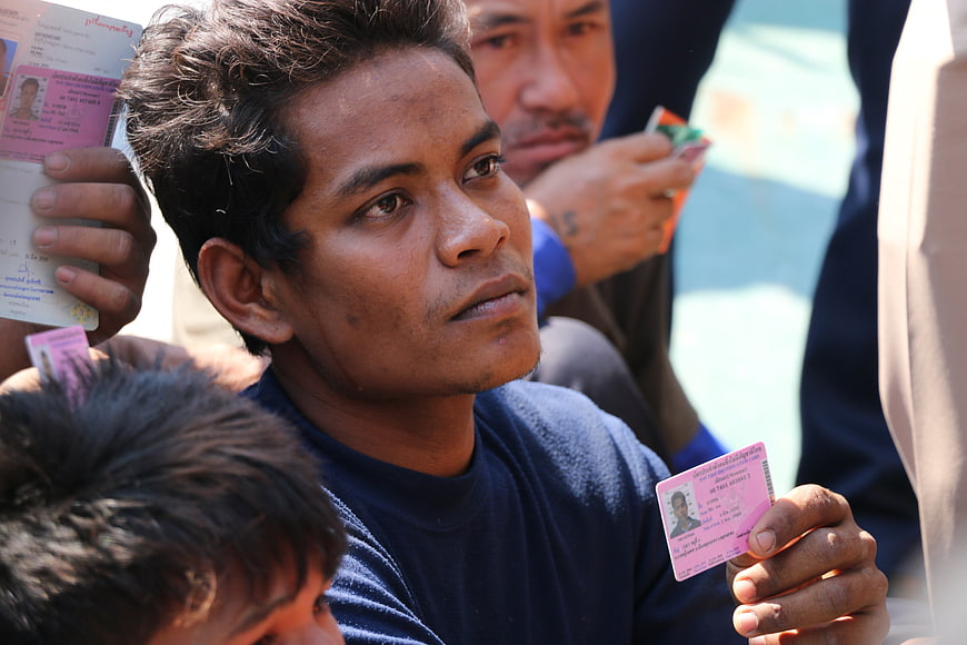 Close-up of man holding identification card during border check