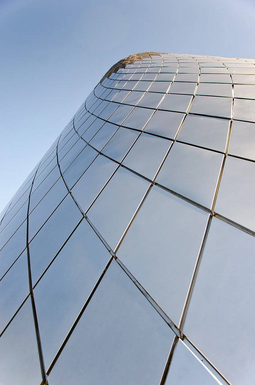Low Angle View of Curved Glass Skyscraper Facade