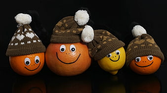 Cute citrus fruits wearing winter hats with smiling faces