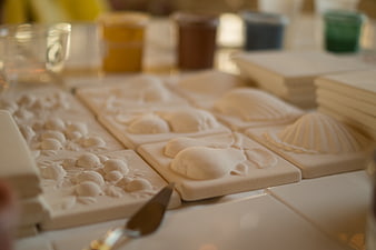 White ceramic tile molds with sea shell and fruit designs