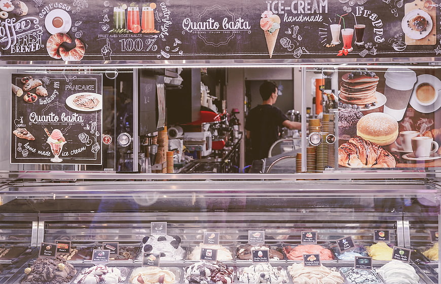 Gelato shop counter with colorful ice cream and menu