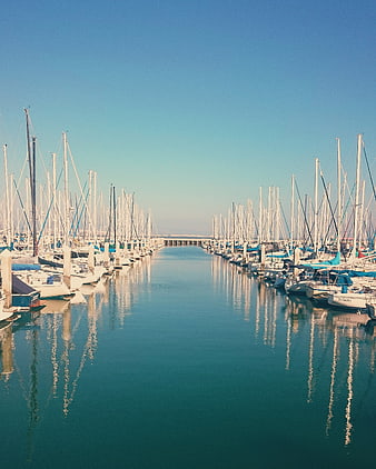 Symmetrical Marina with Sailboats and Blue Sky Reflection