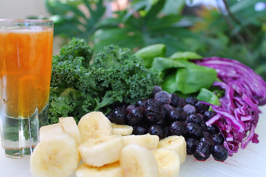 Fresh smoothie ingredients with kale, banana, and blueberries