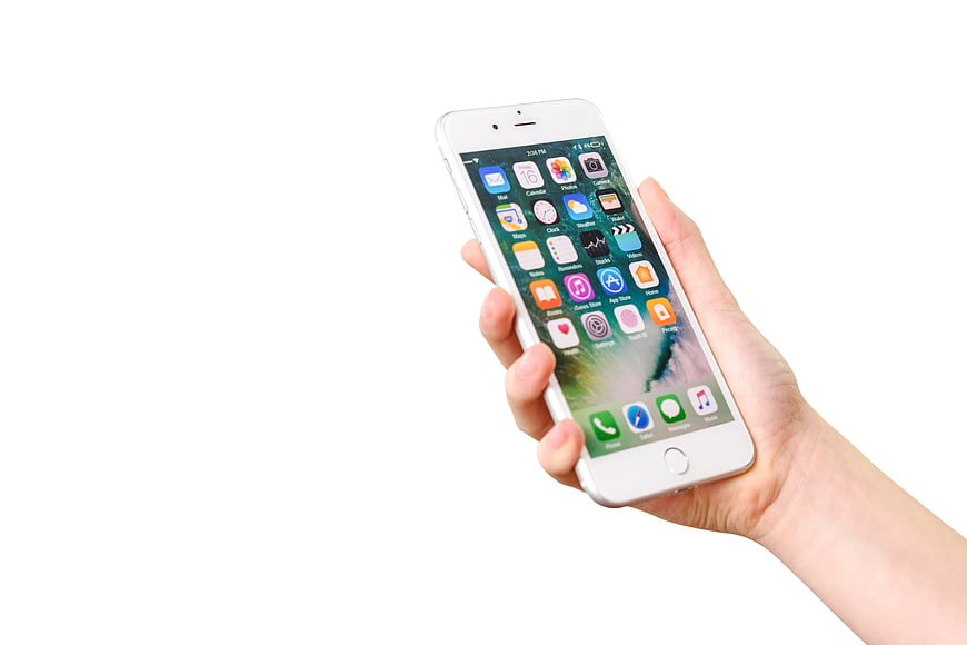 Hand holding white iPhone 7 smartphone with app icons on white background