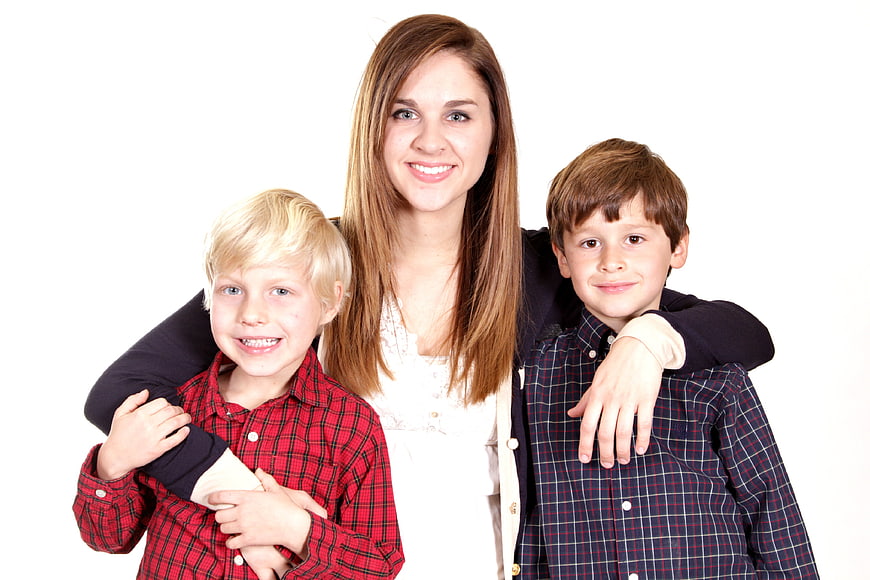 Smiling Mother With Two Young Boys In Plaid Shirts