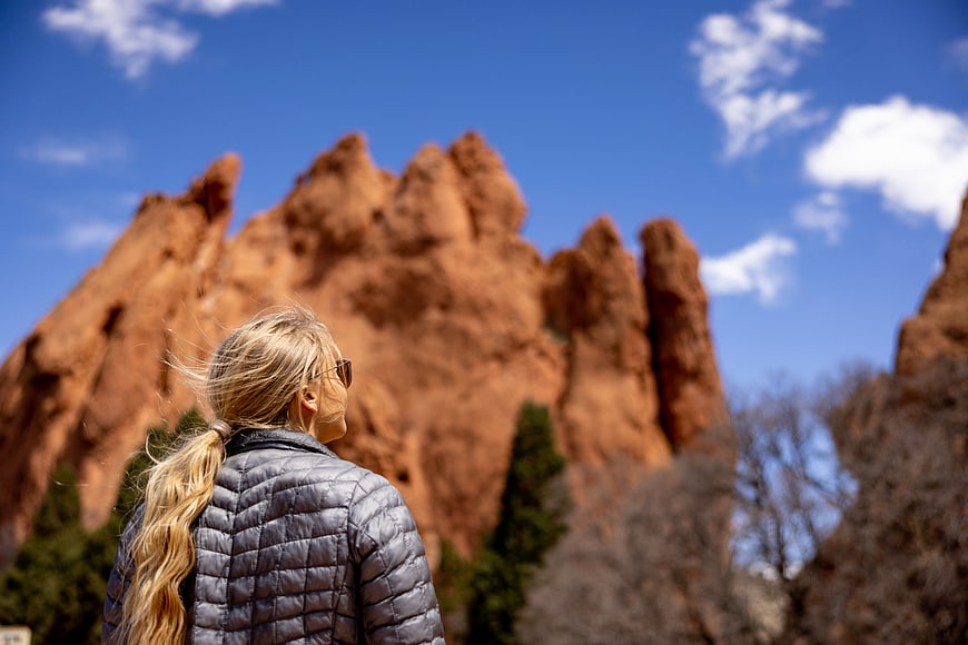Woman Hiking in Front of Red Rocks Colorado Landscape
