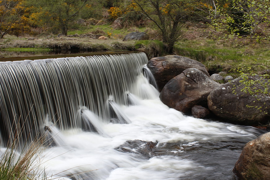 Small waterfall cascading over rocks in a forest stream