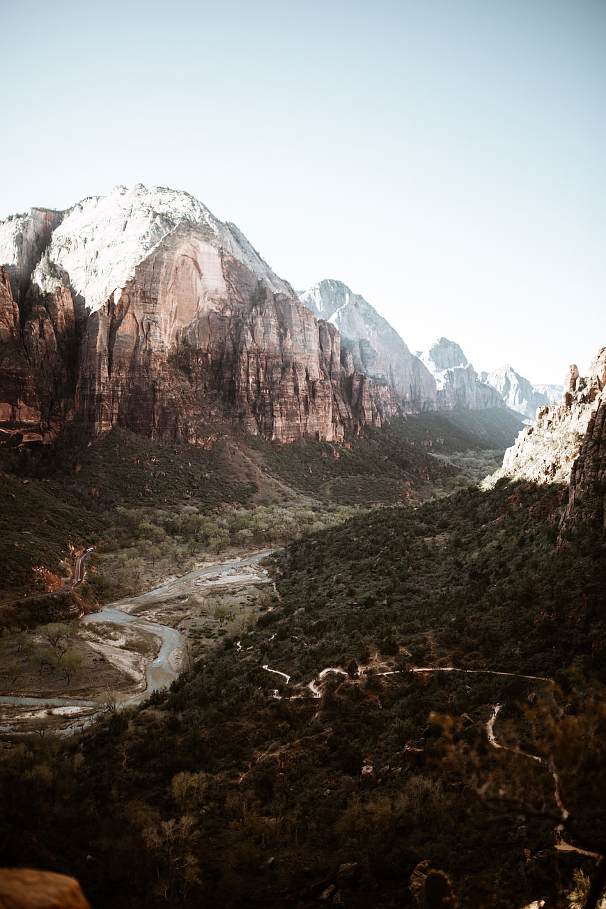 Snow-Capped Red Rock Mountains and River Valley Landscape
