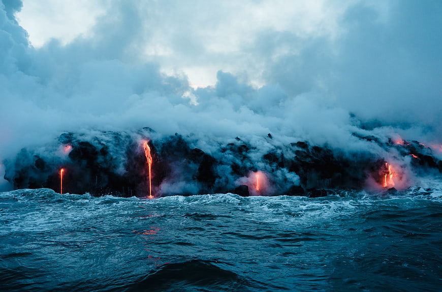 Lava Flowing into Ocean with Steam and Smoke