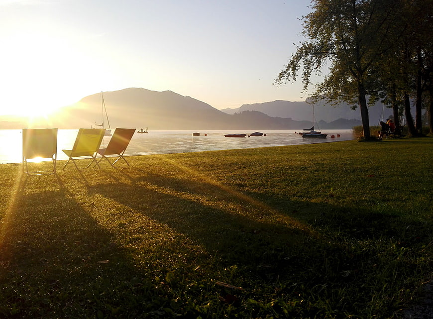 Sunset Lake View with Lounge Chairs and Mountains