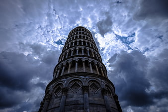 Low Angle View of Leaning Tower of Pisa Against Dramatic Clouds