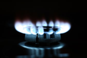 Close-up of blue gas stove flame on black background